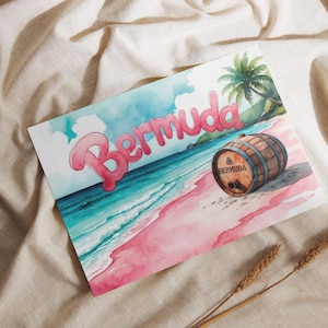 May include: Watercolor illustration of a Bermuda beach scene. The word "Bermuda" is in pink bubble letters. A wooden barrel with "Bermuda" printed on it sits on the pink sand. Palm trees and turquoise water are visible.