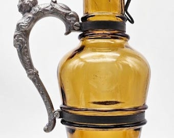Antique cognac bottle circa 1900 – amber-colored glass decanter with figurative handle, 27.5 cm