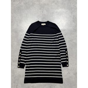 May include: A long-sleeve sweater dress featuring a navy blue and white horizontal striped pattern. The garment has a round neckline and a row of four metallic silver buttons on the outer side of each cuff. The solid navy blue yoke is plain.