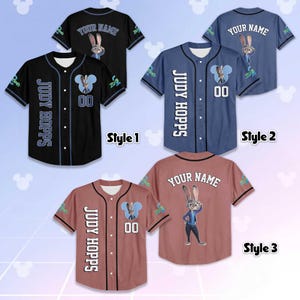 May include: Baseball jerseys in black, blue, and reddish-brown, each featuring a cartoon rabbit character. The jerseys display "JUDY HOPPS" and "YOUR NAME" with the number "00". The design includes a cartoon character and a Mickey Mouse-shaped logo.