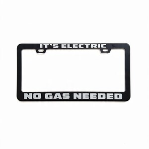 May include: Black license plate frame with the text "IT'S ELECTRIC" at the top and "NO GAS NEEDED" at the bottom in white block letters. The frame has a rectangular shape with rounded corners and mounting holes.