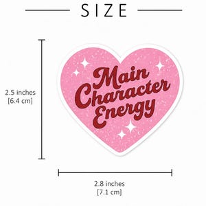 May include: A heart-shaped sticker with a pink textured background, white star accents, and the dark red text Main Character Energy. The sticker measures 2.5 inches in height and 2.8 inches in width as indicated by the visible measurement lines.