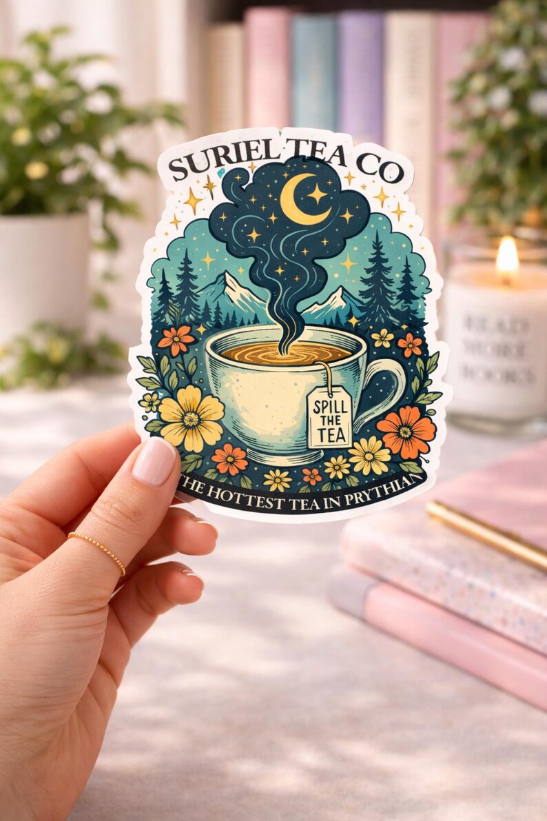 May include: A die-cut sticker featuring a teacup with steam rising into a night sky with a crescent moon and stars. The text reads SURIEL TEA CO at the top, SPILL THE TEA on the tea bag tag, and THE HOTTEST TEA IN PRYTHIAN at the bottom.