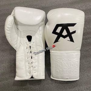 May include: A pair of white boxing gloves with black accents. The gloves have a lace-up closure and the text "NO BOXING NO LIFE" is embossed on one glove. The other glove has a black "A" logo.