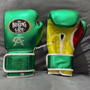 May include: Two boxing gloves. One is green with white accents and the text "NO BOXING NO LIFE". The other glove is yellow with green accents and red details. Both gloves have a wrist strap with the text "BOXING NO LIFE".