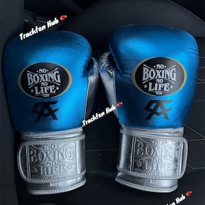 May include: A pair of blue and silver boxing gloves with the text "NO BOXING NO LIFE" on the front. The gloves have a silver strap with the same text on it.