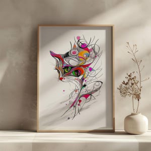 May include: A framed art print featuring a colorful abstract cat design. The cat's head is rendered with vibrant hues of red, orange, green, and pink, with a mix of geometric and organic shapes. The artwork is set against a white background.