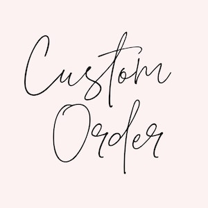 May include: Handwritten text in black ink that reads "Custom Order" on a white background.