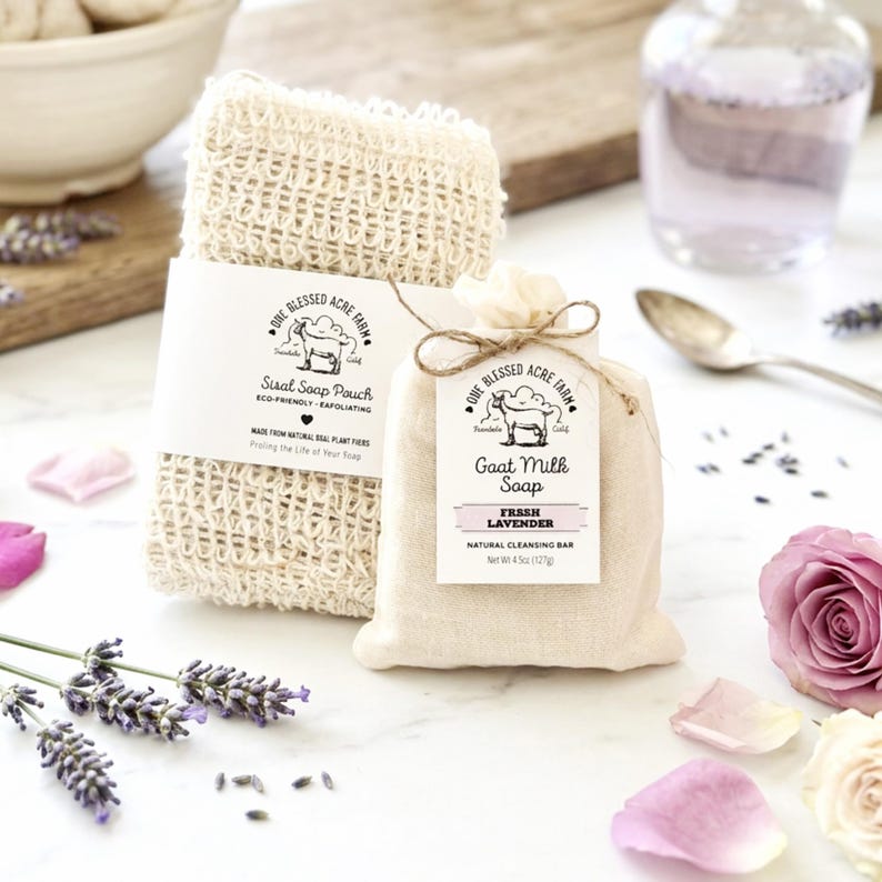 May include: A rectangular beige sisal soap pouch with a white paper label reading One Blessed Acre Farm Sisal Soap Pouch and a small beige fabric bag containing goat milk soap with a tag reading One Blessed Acre Farm Goat Milk Soap Fresh Lavender.