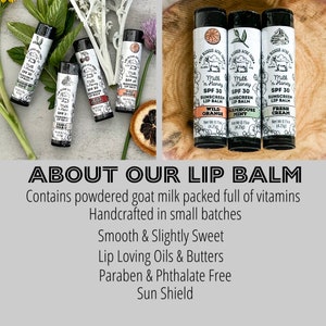 May include: Four different flavored lip balms with goat milk, SPF 30 sunscreen, and a variety of scents including Wild Orange, Farmhouse Mint, and Fresh Cream. The lip balms are handcrafted in small batches and are paraben and phthalate free.  The lip balms are displayed on a wooden surface with a green plant in the background.