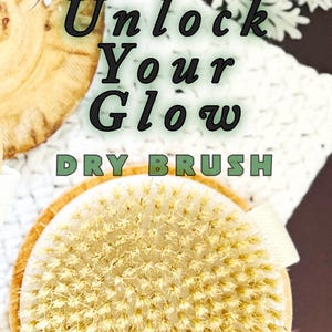 May include: A round dry brush with light-colored natural bristles and a wooden base featuring a beige fabric strap. The text Unlock Your Glow DRY BRUSH and One Blessed Acre Farm is printed over the image of the brush and wooden accents.