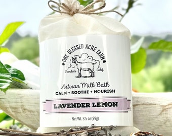 May include: A white muslin bag with a brown twine tie, containing a lavender lemon artisan milk bath. The bag has a black and white logo with a goat and the text "One Blessed Acre Farm, Ferndale Calif." The product description reads "Artisan Milk Bath, Calm Soothe Nourish, Lavender Lemon, Net Wt. 3.5 oz (99g)"