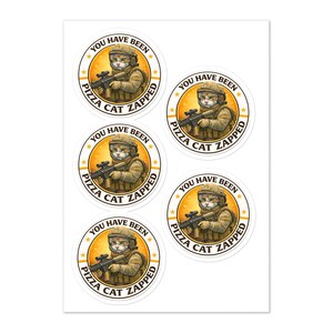 May include: A sheet of round stickers featuring a cat in military gear holding a rifle. The stickers have the text "YOU HAVE BEEN PIZZA CAT ZAPPED" in a circular design with stars and a yellow and orange background.