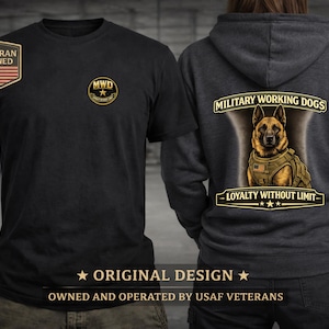 May include: Black t-shirt and gray hoodie featuring military working dog designs. The t-shirt has a "MWD" logo and a "Veteran Owned" patch. The hoodie displays a German Shepherd illustration with the text "MILITARY WORKING DOGS" and "LOYALTY WITHOUT LIMIT".