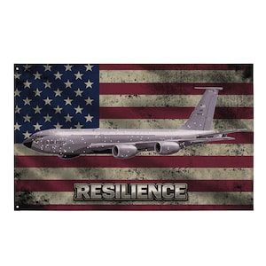 May include: A metal sign featuring a vintage American flag design with a gray aircraft. The words "RESILIENCE" are displayed in a silver, block font. The words "US AIR FORCE" are printed on the aircraft.