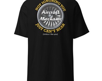 May include: Black t-shirt with a yellow circle graphic featuring a jet engine and the text "Not ignoring you Aircraft Mechanic Just can't hear (Unless I like you)"