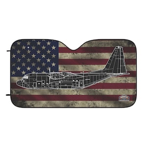 May include: A rectangular windscreen sun shade featuring a distressed American flag background with a white line drawing of a C-130 Hercules transport aircraft in the centre. The bottom right corner displays a small logo with the text HANGAR 2A.