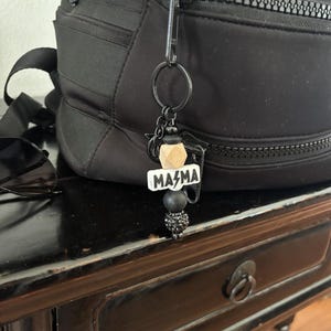 a bag with a keychain that says mama on it