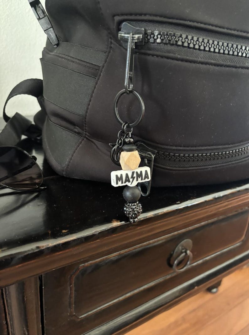 a bag with a keychain that says mama on it