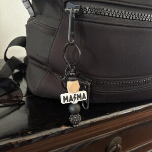 a bag with a name tag and a keychain attached to it