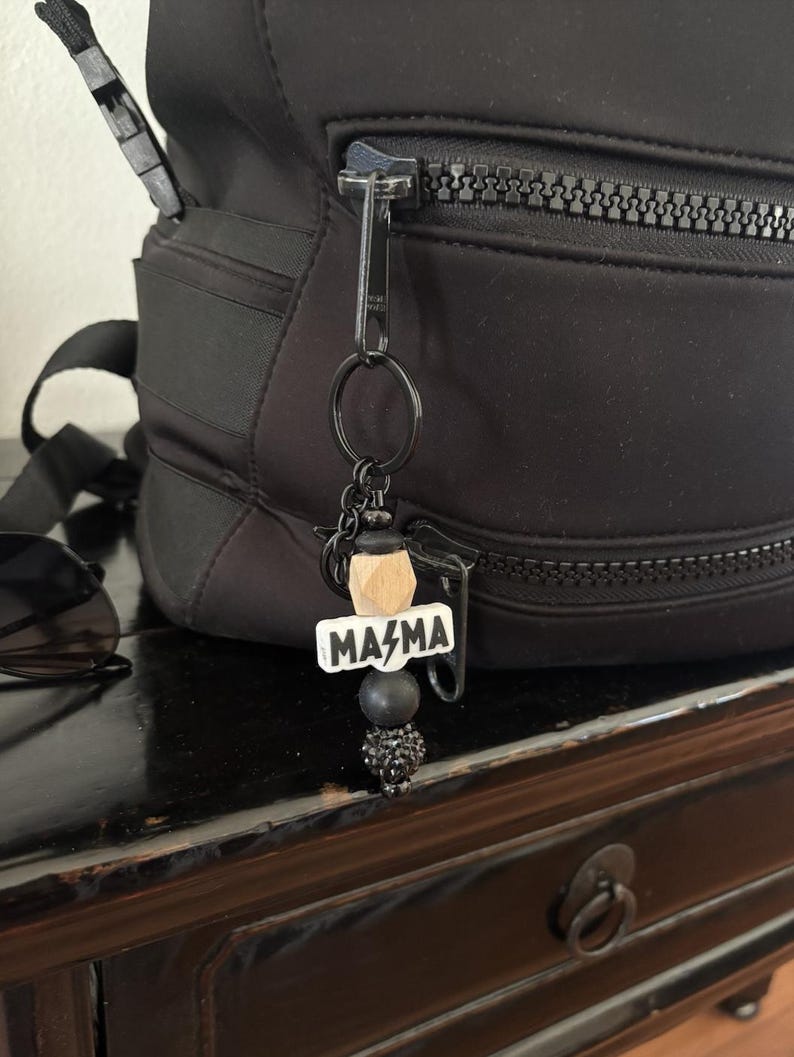 a bag with a name tag and a keychain attached to it