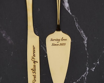 May include: A gold-colored cake knife and server set. The knife reads "First Slice of Forever" and the server reads "Serving love Since 2025". The set is displayed on a black marble-patterned surface.