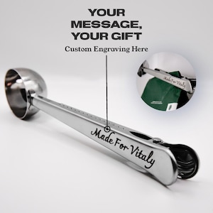 May include: Silver measuring spoon with a clip and a personalized engraving that reads "Made For Vitaly".