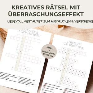 May include: Two white crossword puzzles with German text. The top text reads "KREATIVES R&Auml;TSEL MIT &Uuml;BERRASCHUNGSEFFEKT" and "LIEBEVOLL GESTALTET ZUM AUSDRUCKEN & VERSCHENKEN". One puzzle is labelled "FRAGEN & 1 &Uuml;BERRASCHUNG" and the other "L&Ouml;SUNGEN (DU WIRST OPA)". A circular graphic reads "R&Auml;TSEL + AUFL&Ouml;SUNGEN ENTHALTEN".