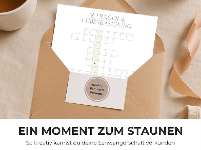 May include: A tan envelope containing a white card with a crossword puzzle and the text "12 FRAGEN & 1 &Uuml;BERRASCHUNG." A small card with the text "Ideal f&uuml;r Familie & Freunde" is also visible. The phrase "EIN MOMENT ZUM STAUNEN" is at the bottom.