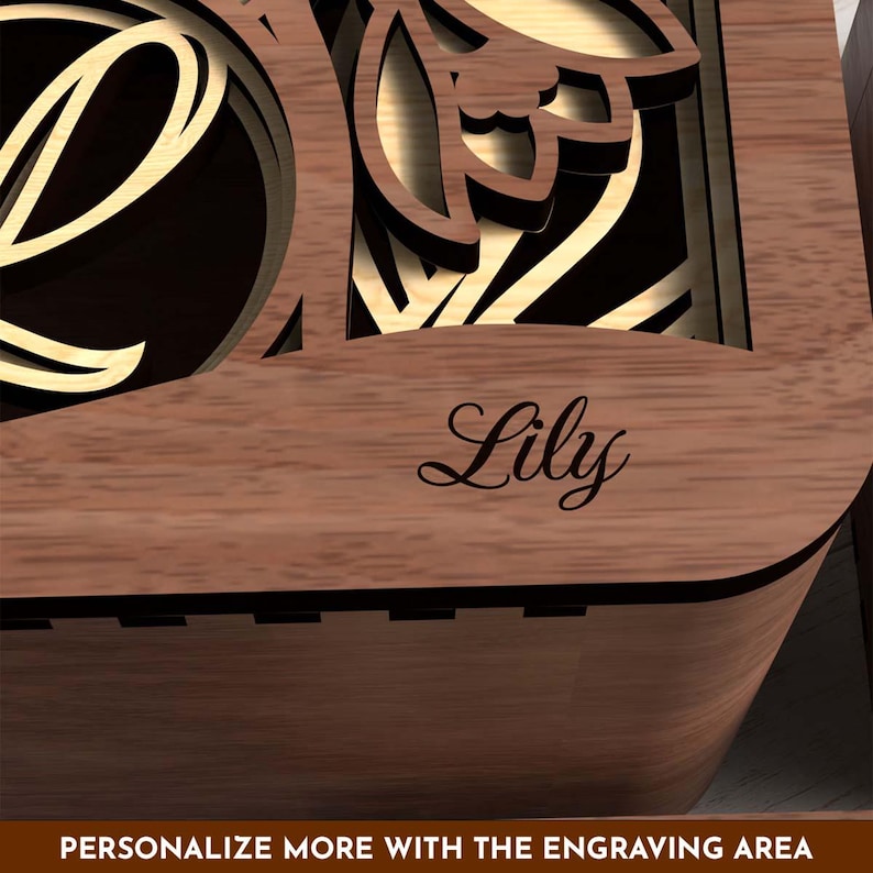 Close-up of personalized name engraving on wooden gift box surface