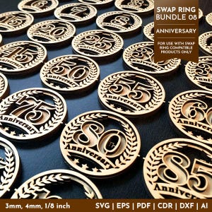 May include: A collection of laser-cut wooden anniversary tokens. Each token features a number representing an anniversary year, surrounded by a laurel wreath and the word "Anniversary". The tokens are available in 3mm, 4mm, and 1/8 inch thicknesses.