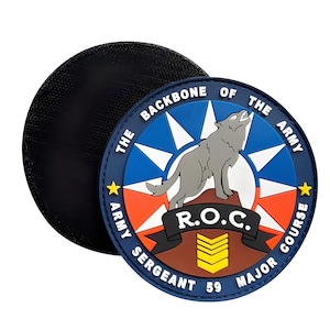 May include: A blue, red and white circular patch featuring a wolf howling at the moon. The patch has the text "The Backbone of the Army" and "Army Sergeant 59 Major Course" around the edge. The text "R.O.C." is in the centre of the patch.