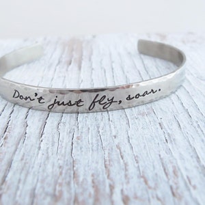 Don't just fly, soar custom hand stamped bracelet cuff, inspirational, graduation gift, nickel silver, she flies on her own wings