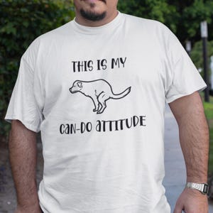 May include: White t-shirt with a black and white illustration of a dog pooping and the text "This is my can-do attitude."