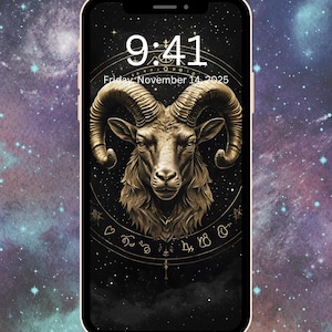 May include: A smartphone displays a golden ram illustration, the Aries zodiac sign, on a black background with a starry night sky. The time is 9:41 AM, Friday, November 14, 2025. The phone has a gold-colored frame.