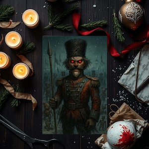 May include: A dark, artistic print of a menacing nutcracker soldier with glowing red eyes, holding a spear. The image is surrounded by lit candles, Christmas ornaments, and festive decorations on a dark wooden surface.