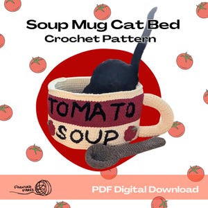 May include: A crochet cat bed shaped like a tomato soup mug, with a black cat inside. The mug is cream-colored with a red band that reads "TOMATO SOUP". A crochet spoon rests beside the mug. The words "Soup Mug Cat Bed Crochet Pattern" are at the top.