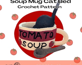 May include: A crochet cat bed in the shape of a tomato soup mug, with a black cat inside. The mug is cream-coloured with a red band that reads "TOMATO SOUP". A crochet spoon rests beside the mug. The words "Soup Mug Cat Bed Crochet Pattern" are at the top.