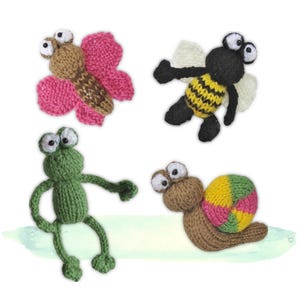 May include: Four small knitted animal figures including a brown butterfly with pink wings, a black and yellow striped bee with white wings, a green frog with long limbs, and a brown snail with a multi-coloured shell featuring pink, yellow, and green.