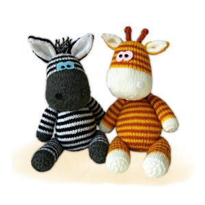 May include: Two handmade knitted animal toys: a zebra with black and white stripes and a giraffe with orange and yellow stripes. The zebra has black and white ears and the giraffe has small brown horns.