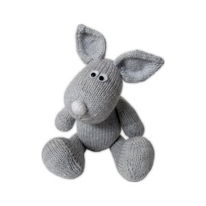 May include: A handmade gray knitted bunny toy with large ears, a white nose, and black eyes. The plush bunny is sitting with its legs outstretched. The toy is made of soft yarn and is suitable for children.