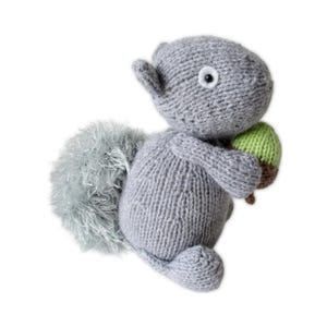 May include: A set of three ceramic mugs with a speckled, cream-colored glaze. Each mug features a different hand-painted floral design in shades of blue, green, and yellow. The mugs have a simple, rounded shape and a comfortable handle.