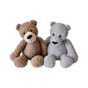May include: Two plush teddy bears. One is brown with a black nose and a cream-colored muzzle. The other is gray with a black nose. Both have a soft, textured appearance and are sitting upright.