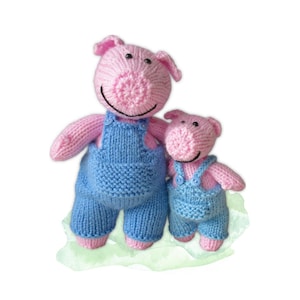 May include: Two knitted pig figurines. The pigs are pink with blue overalls. The larger pig has a smiling face with black eyes and a black smile. The smaller pig has a similar design. The pigs are standing on a light green watercolor background.