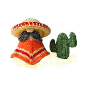 Può includere: Figure fatte a mano a maglia di un personaggio con sombrero, baffi e poncho arancione con strisce rosse e bianche, accanto a un cactus verde. Il sombrero è giallo con un bordo arancione e rosso.