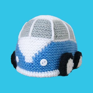 May include: A handmade wooden sign with the text "Welcome to our home" in a handwritten style. The sign is painted white with a dark stained wooden frame. A small green plant is placed on the sign.