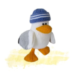 May include: A knitted seagull toy wearing a blue and white striped hat, with an orange beak and feet, and grey and white wings. The seagull has black eyes. The toy is made of white yarn.