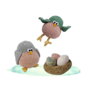 May include: Hand-knitted bird figurines in pink, grey, and green with yellow feet and beaks. One bird is in flight, while another sits beside a nest with three knitted eggs. The nest is brown and the eggs are in shades of pink, blue, and white.