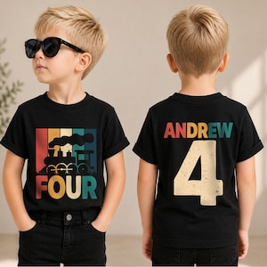 May include: A black short-sleeved t-shirt featuring a retro-style graphic of a steam train with the word FOUR in multi-colored block letters on the front and the name ANDREW above the number 4 in a distressed font on the back.