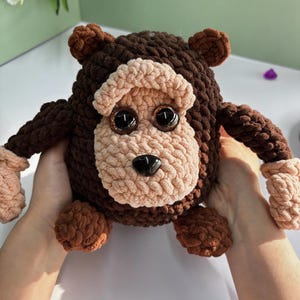 May include: A handmade wooden sign displaying the word "Welcome" in a whimsical font. The sign has a distressed white backdrop and a dark brown frame, suitable for a front door or hallway.